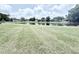 A large grassy area featuring a pond in the background at 4001 Misty Morning Pl, Casselberry, FL 32707