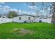 Spacious backyard with a large grassy area and white vinyl fence at 4333 Arch St, Orlando, FL 32808