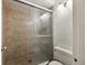 Simple bathroom with a shower, toilet, and tiled walls at 600 Cranes Way # 206, Altamonte Springs, FL 32701