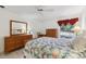Well-lit bedroom featuring a comfy bed and ample wood furniture at 600 Cranes Way # 206, Altamonte Springs, FL 32701