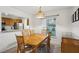 Bright dining area with wood table, chairs, and kitchen view at 600 Cranes Way # 206, Altamonte Springs, FL 32701