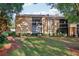 Condo building with balconies and green lawn, nestled among trees at 600 Cranes Way # 206, Altamonte Springs, FL 32701
