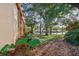 Side view of condo building showcasing landscaping and tree-lined walkway at 600 Cranes Way # 206, Altamonte Springs, FL 32701
