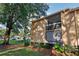 Condo building with balcony and lush green landscaping at 600 Cranes Way # 206, Altamonte Springs, FL 32701