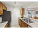 Kitchen features stainless steel sink and wood cabinets at 600 Cranes Way # 206, Altamonte Springs, FL 32701