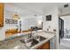 Kitchen with granite countertops, double sink, and view to dining area at 600 Cranes Way # 206, Altamonte Springs, FL 32701