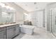 Elegant bathroom with double vanity and soaking tub at 6054 Bimini Twist Loop, Orlando, FL 32819