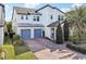 Two-story home with gray double garage doors and manicured landscaping at 6054 Bimini Twist Loop, Orlando, FL 32819