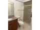 Bathroom features a shower with glass door, granite counter, and tile floors at 607 Waverly Ln # 403, Maitland, FL 32751