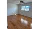 Spacious bedroom with hardwood floors, ceiling fan, and a window with natural light at 607 Waverly Ln # 403, Maitland, FL 32751