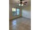 The bedroom features neutral paint, tile flooring, and a ceiling fan for comfort at 607 Waverly Ln # 403, Maitland, FL 32751