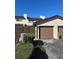 Attached garage, a well-kept lawn, and plants create a warm welcome to the property at 607 Waverly Ln # 403, Maitland, FL 32751