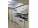 Bright kitchen featuring white cabinets, a microwave, and tile flooring for easy upkeep at 607 Waverly Ln # 403, Maitland, FL 32751