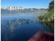 Lake view from dock area featuring foliage and condominium buildings at 607 Waverly Ln # 403, Maitland, FL 32751