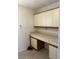 Laundry room featuring a laminate counter, storage cabinets and tile floors at 607 Waverly Ln # 403, Maitland, FL 32751