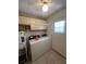Washer and dryer hookups in laundry room with overhead lighting and storage at 607 Waverly Ln # 403, Maitland, FL 32751