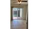 Bright living room featuring tile floors and sliding glass doors to outdoor patio at 607 Waverly Ln # 403, Maitland, FL 32751
