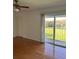 Bright living room featuring hardwood floors and sliding glass doors to outdoor balcony at 607 Waverly Ln # 403, Maitland, FL 32751