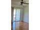 Bright living room featuring hardwood floors and sliding glass doors to outdoor balcony at 607 Waverly Ln # 403, Maitland, FL 32751