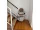 Stairway with stair lift, hardwood floors, and a safety railing for accessibility at 607 Waverly Ln # 403, Maitland, FL 32751