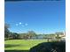 Scenic view from the condo with a beautiful lawn, pool, trees, and blue skies at 607 Waverly Ln # 403, Maitland, FL 32751
