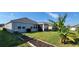 Backyard view of home with garden and screened patio at 648 Daring Dr, Davenport, FL 33837
