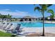 Community pool with lounge chairs and shaded seating areas at 648 Daring Dr, Davenport, FL 33837