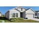 Beautiful one-story home with a two-car garage and manicured lawn at 648 Daring Dr, Davenport, FL 33837