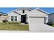 Two-car garage and well-maintained lawn at 648 Daring Dr, Davenport, FL 33837