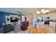 Open floor plan with kitchen island, stainless steel appliances, and living area at 648 Daring Dr, Davenport, FL 33837