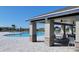 Community pool and covered patio with seating at 648 Daring Dr, Davenport, FL 33837