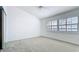 Bright bedroom with a ceiling fan, and large windows with shutter-style blinds at 660 Killarney Bay Ct # 6, Winter Park, FL 32789