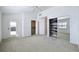 Light-filled bedroom with mirrored closet doors and access to an outdoor balcony at 660 Killarney Bay Ct # 6, Winter Park, FL 32789