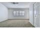 Spacious bedroom featuring neutral carpet, ceiling fan, and large windows with shutter-style blinds at 660 Killarney Bay Ct # 6, Winter Park, FL 32789