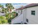 The condo has exterior stairs with lush tropical landscaping and an exterior AC unit at 660 Killarney Bay Ct # 6, Winter Park, FL 32789
