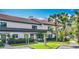 Exterior of home showing the carport, landscaping, and walkway at 660 Killarney Bay Ct # 6, Winter Park, FL 32789