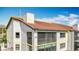 Exterior view of the two-story condo building with a screened in lanai and tile roof at 660 Killarney Bay Ct # 6, Winter Park, FL 32789