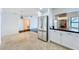Bright kitchen with stainless steel refrigerator and an adjacent living area at 660 Killarney Bay Ct # 6, Winter Park, FL 32789
