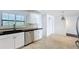 Stylish kitchen featuring white cabinets, tile backsplash, and stainless steel appliances at 660 Killarney Bay Ct # 6, Winter Park, FL 32789