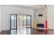 Open living room with fireplace, balcony, and dark, shiny hardwood floors at 660 Killarney Bay Ct # 6, Winter Park, FL 32789