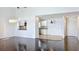 Open concept living room with hardwood floors, open to the kitchen with white cabinets at 660 Killarney Bay Ct # 6, Winter Park, FL 32789