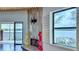 Living room with fireplace and water views from a big window and the balcony doors at 660 Killarney Bay Ct # 6, Winter Park, FL 32789