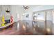 Bright living room showcasing the fireplace, view of the kitchen, and shiny hardwood floors at 660 Killarney Bay Ct # 6, Winter Park, FL 32789