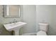 Stylish powder room featuring patterned wallpaper, a pedestal sink and comfort height toilet at 660 Killarney Bay Ct # 6, Winter Park, FL 32789