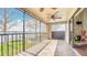 Spacious screened porch with views of the lake and a decorative fireplace with tile floors at 660 Killarney Bay Ct # 6, Winter Park, FL 32789