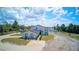 Aerial view of a two-story home with a large yard and driveway at 711 Cypress Ave, Orange City, FL 32763