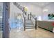 Elegant entryway with a grand staircase, chandelier, and mirror at 711 Cypress Ave, Orange City, FL 32763