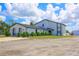 Two-story house exterior, showcasing a modern design and landscaping at 711 Cypress Ave, Orange City, FL 32763