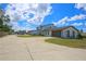 Modern home exterior with gray accents and large driveway at 711 Cypress Ave, Orange City, FL 32763