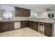 Spacious kitchen with dark cabinetry, granite counters, and stainless steel appliances at 711 Cypress Ave, Orange City, FL 32763